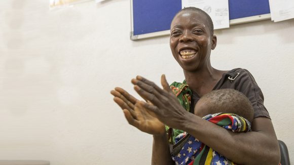 Laurinda laughing and clapping after cataract surgery.