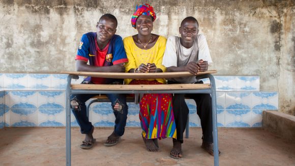 Three people sitting at a desk