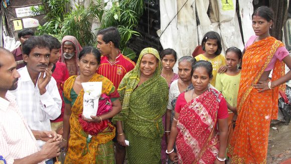 A group of residents in Kolkata, dressed in colourful clothing.