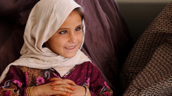 A child patient in LRBT Hospital, Pakistan. She is smiling.