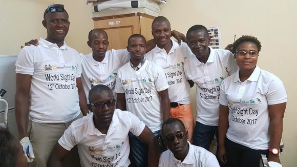 Staff from Makeni Hospital's eyecare team smile for the camera.