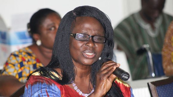 Gertrude Oforiwa Fefoame speaking into a microphone at an event.
