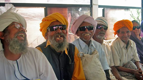A group of cataract patients smile broadly after surgery.