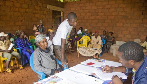 A man writes information on paper.