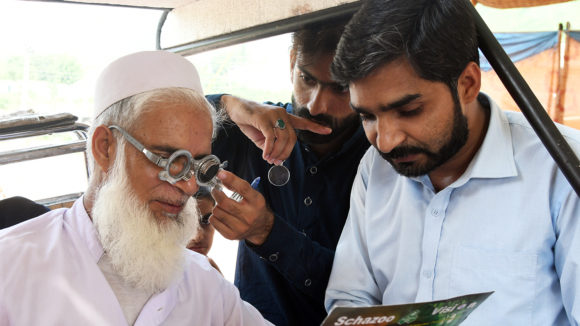 Muhammed has his eyes tested by a health worker.