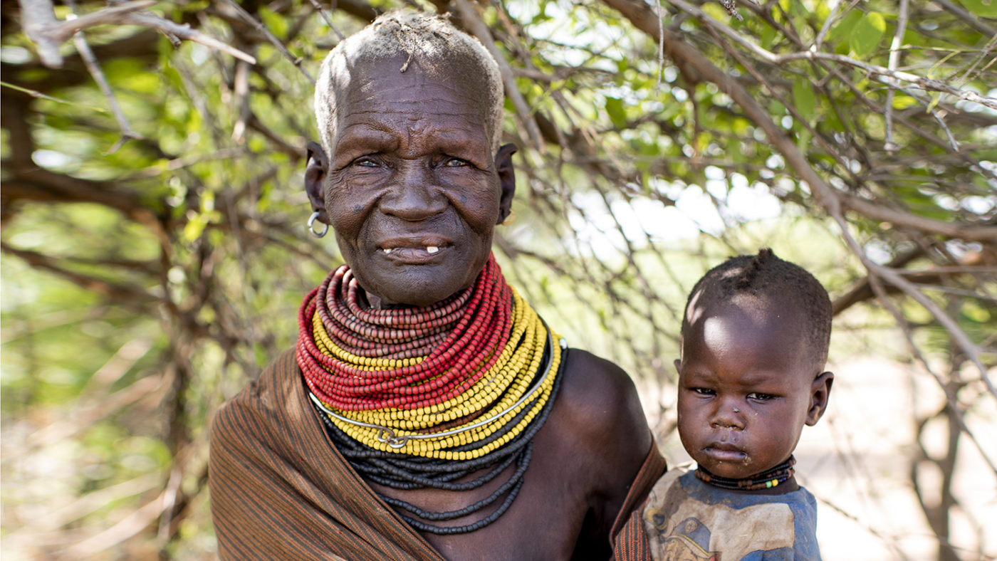 A women holds her baby grandson in her arms.