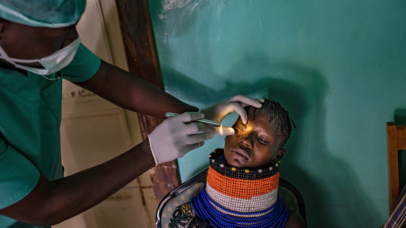 A girl has her eye examined.