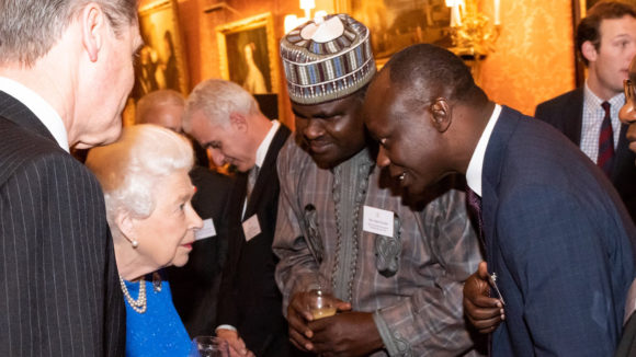 The Queen greets Sunday Isiyaku and other guests at the Buckingham Palace event.