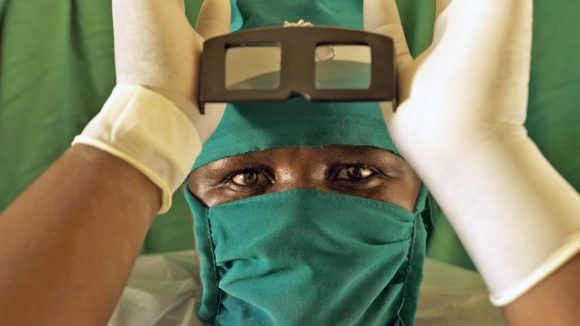 A close-up of Esther Anyango wearing her hospital scrubs.