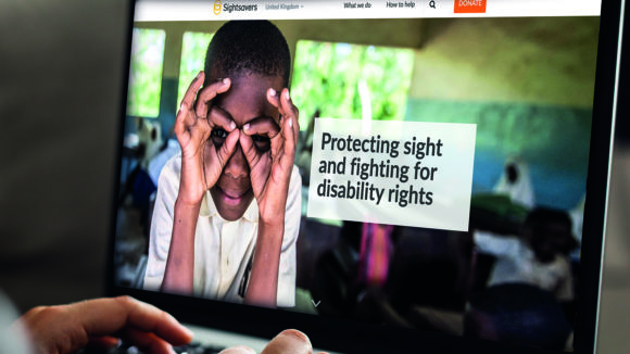 A close-up of a computer screen showing the Sightsavers website home page.