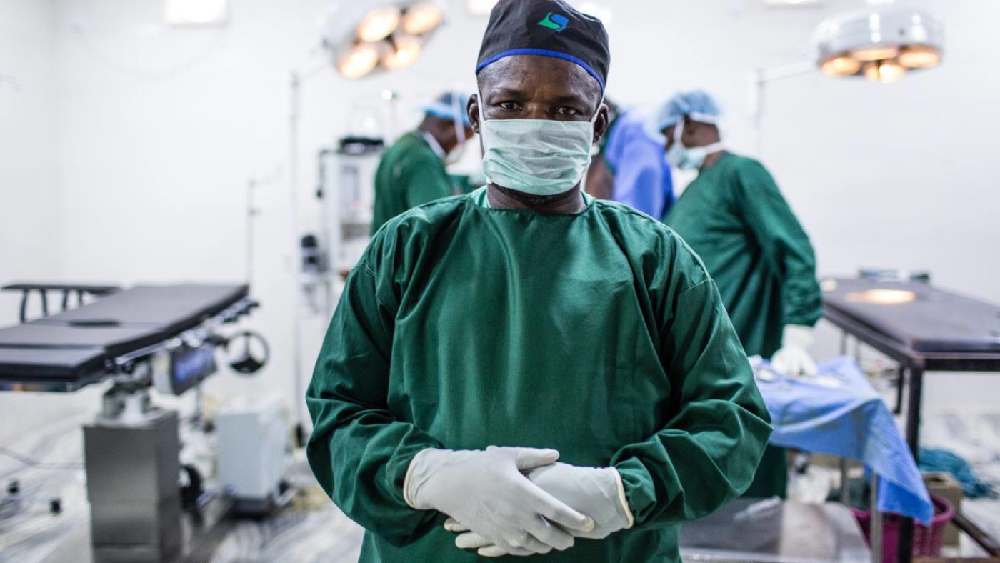 A surgeon stands for a portrait in the operating room.