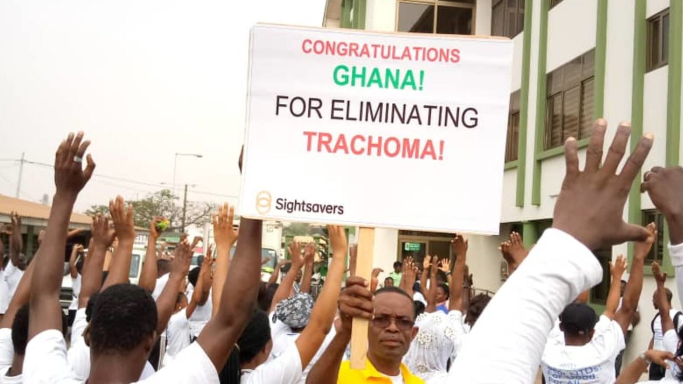 A man holds a sign that says 