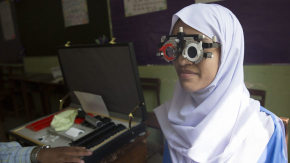 A girl has her eyes tested.