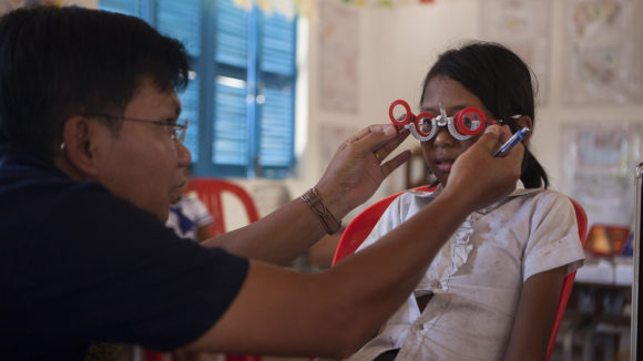 A child has her eyes tested at a school in Cambodia as part of the SHIP project.