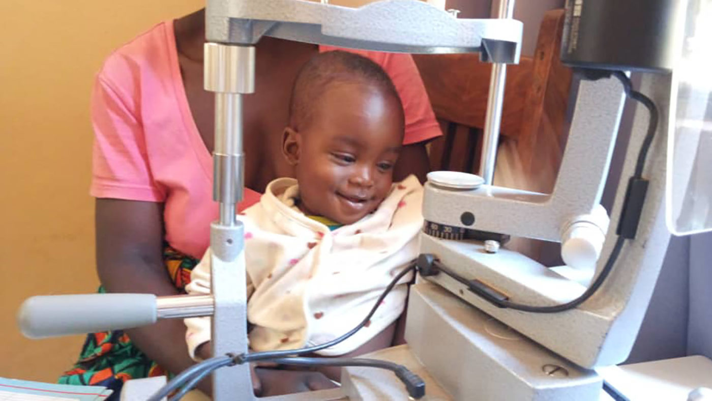 A little boy smiles after having an eye exam.