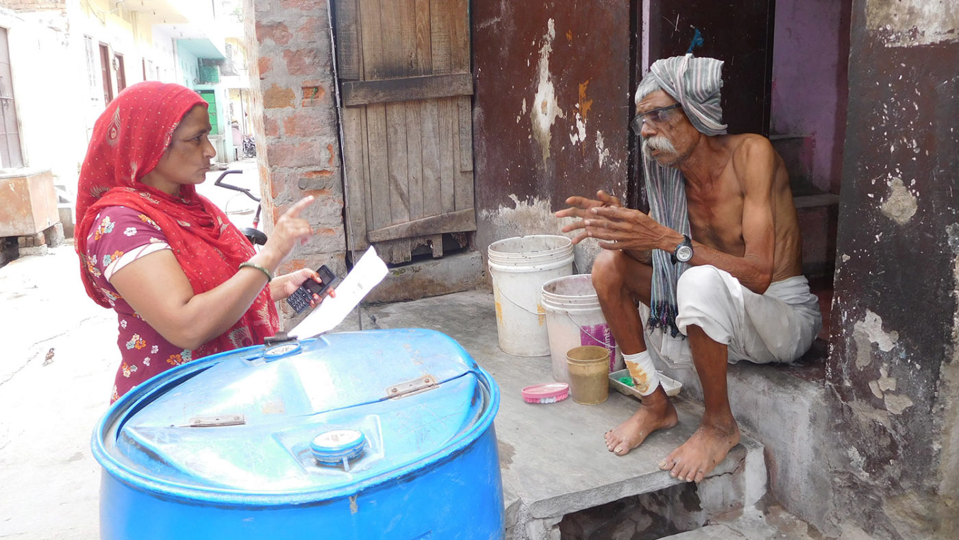 A community volunteer visits a man at his home.