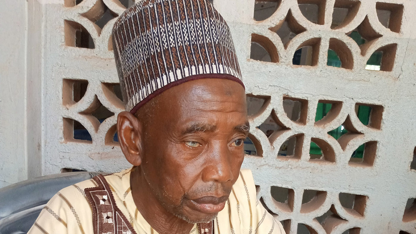 A portrait of a man in traditional clothing.