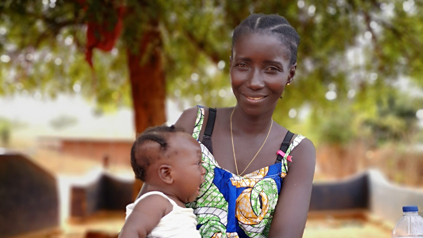 Idalina sits with her baby,