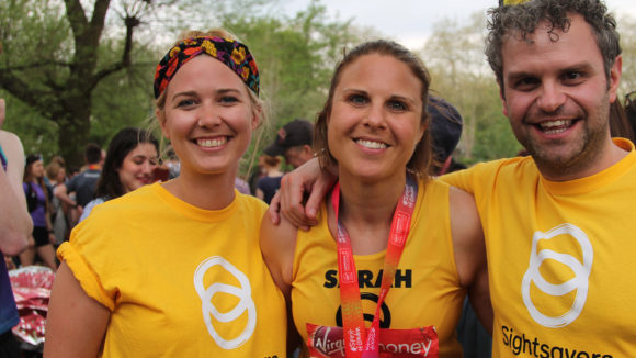 A marathon runner with Sightsavers staff.