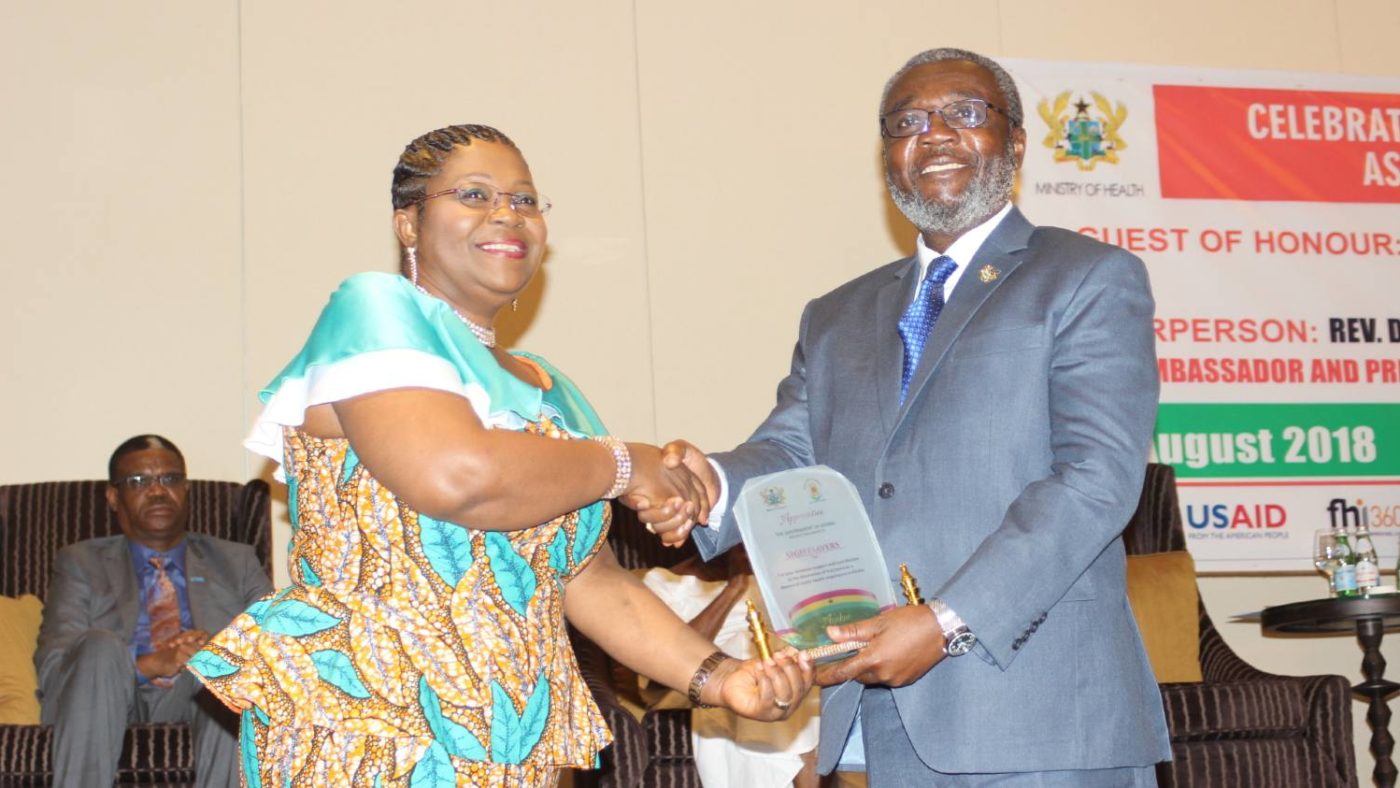 A woman receives an award.