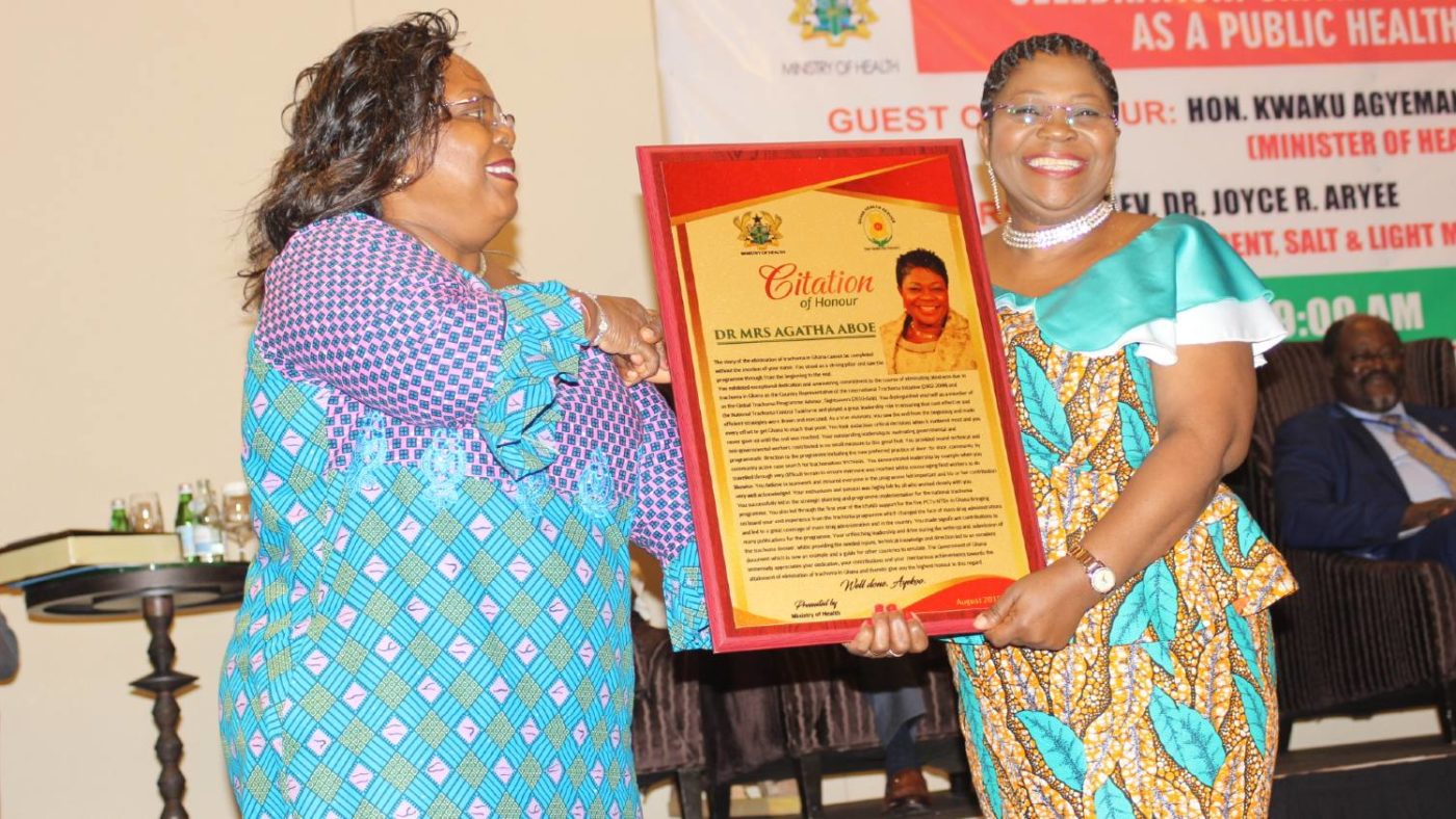 A woman receives an award.