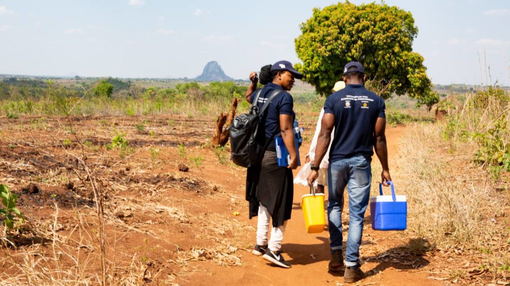 The survey team for the Onchocerciasis Elimination Mapping project in Mozambique walk through the community