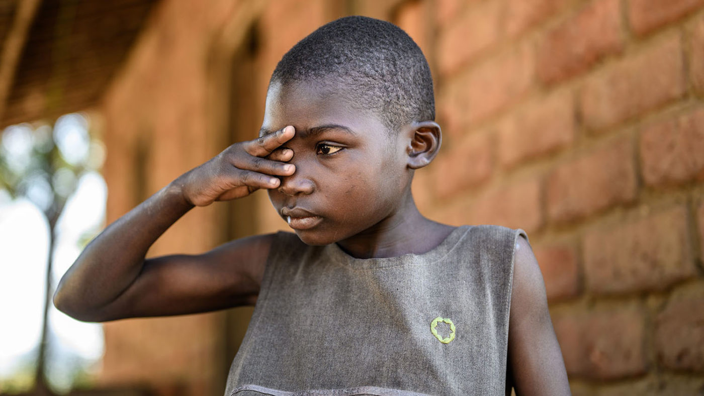 Mary itching her sore eye.