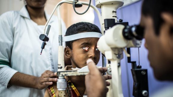 A young boy has an eye check up.