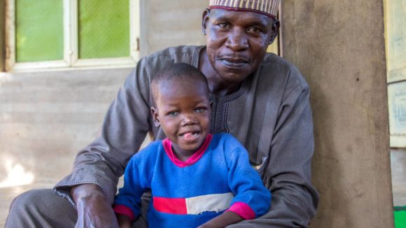 Seven-year-old Muzi together with his father