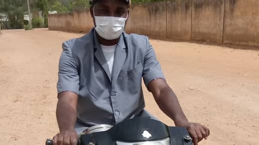 Surgeon Kabir wearing face mask on motorbike
