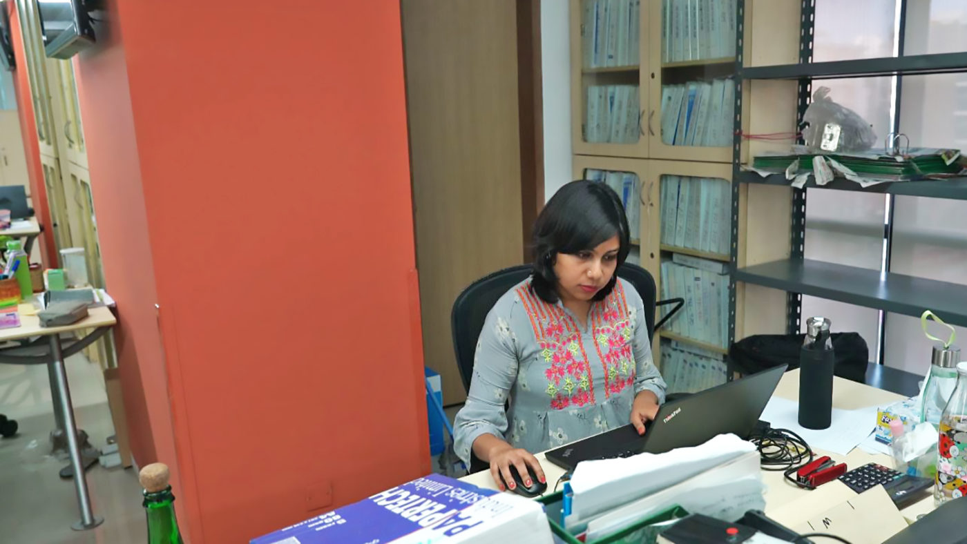 A woman using a laptop.