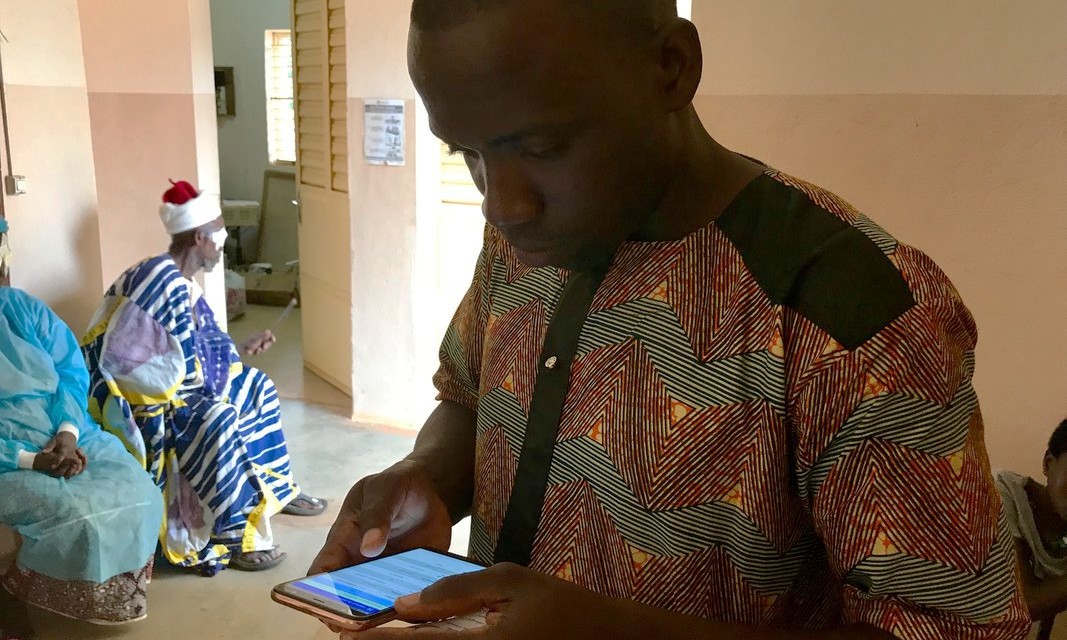 A man holds a mobile phone.