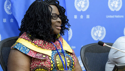 Gertrude Oforiwa Fefoame speaking into a microphone.