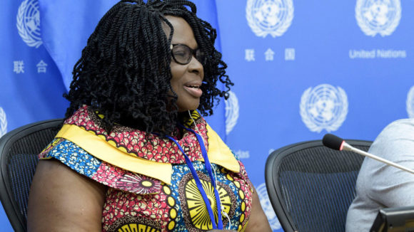 Gertrude Oforiwa Fefoame speaking into a microphone.