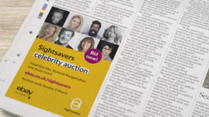 A newspaper containing a Sightsavers branded advert.