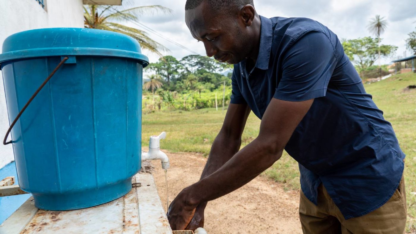 A man washes his hands.