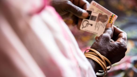 Close up of hands holding a disability identity card.