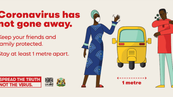 A poster that says 'COVID has not gone away' and showcasing one-meter social distancing.