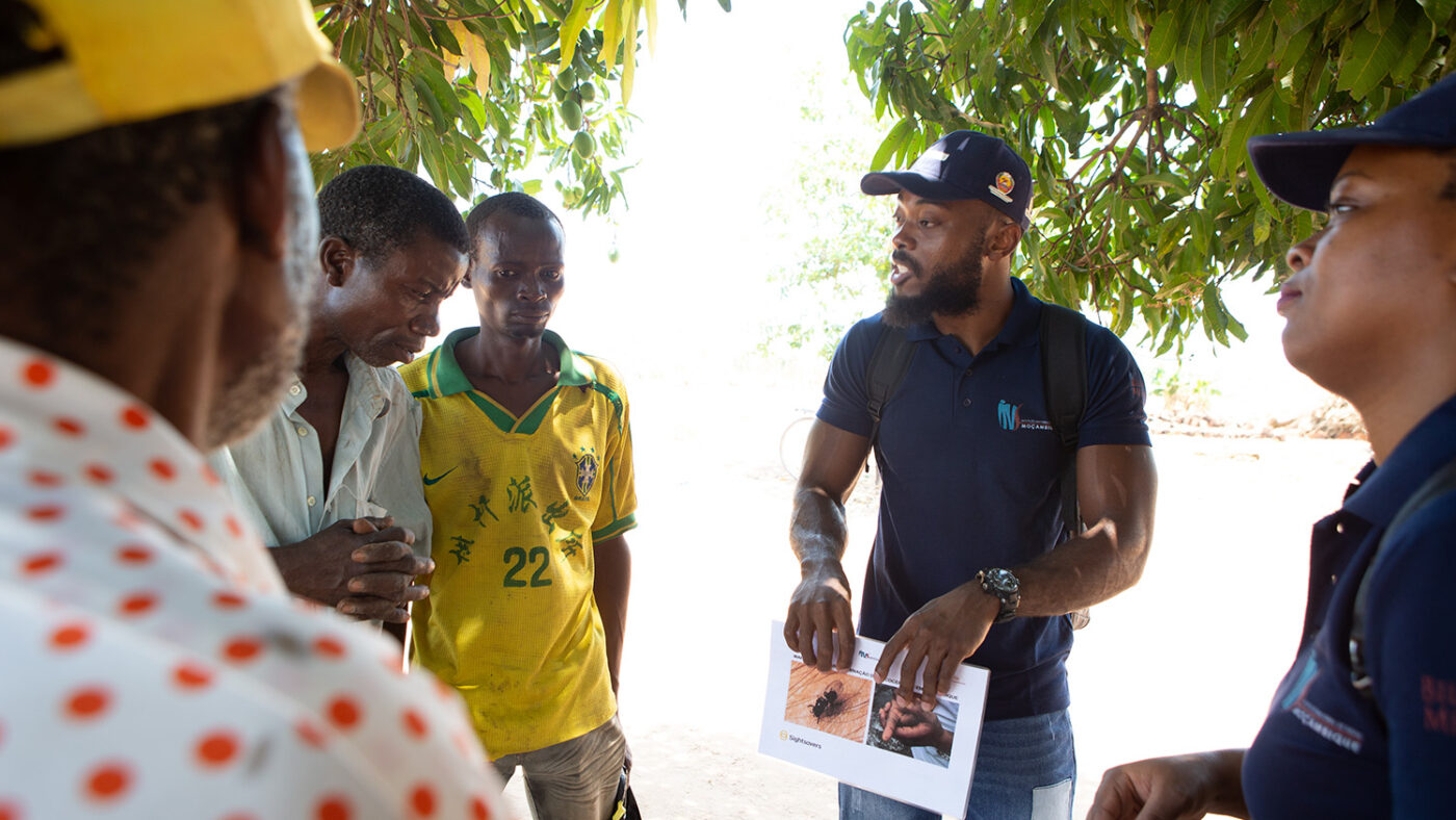 A man shares information about river blindness with a group of people.