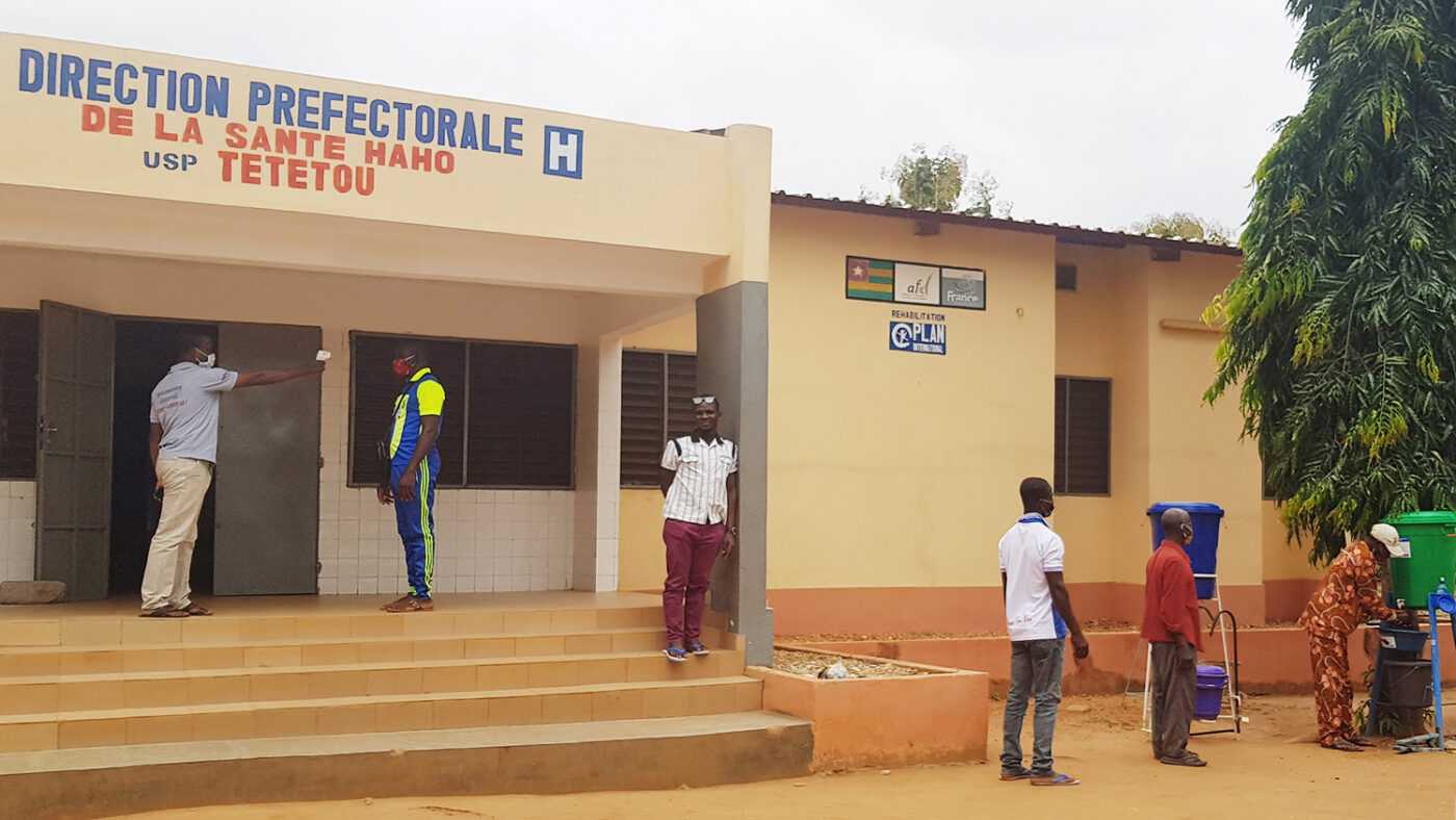 Volunteers have their temperatures checked and wash their hands before attending a training.