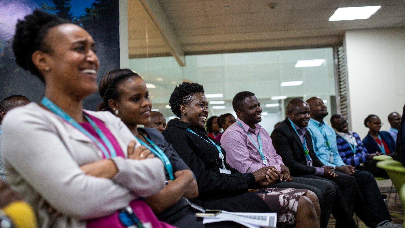A group of people sit in a room.
