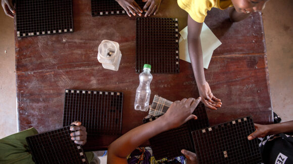 Many braille boards on a table.