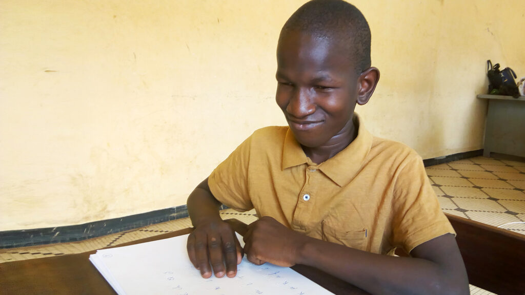 A student using braille.