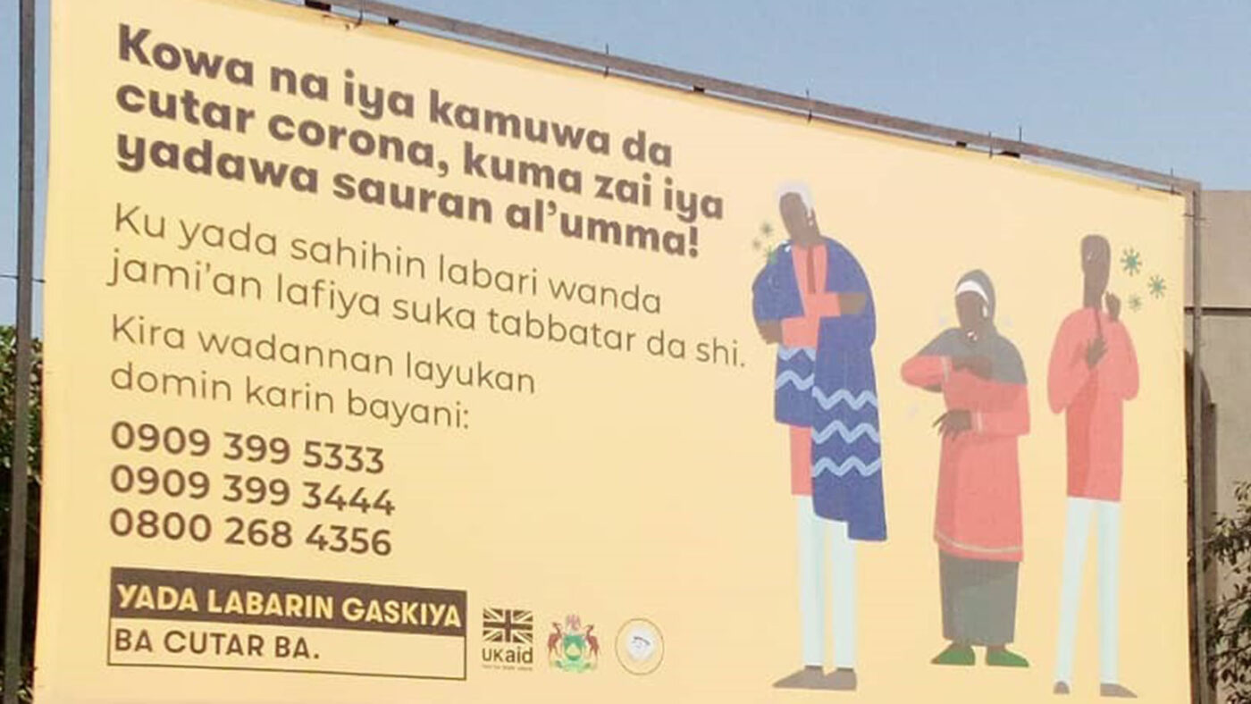 A billboard with COVID-19 messaging on it in local Nigerian language.