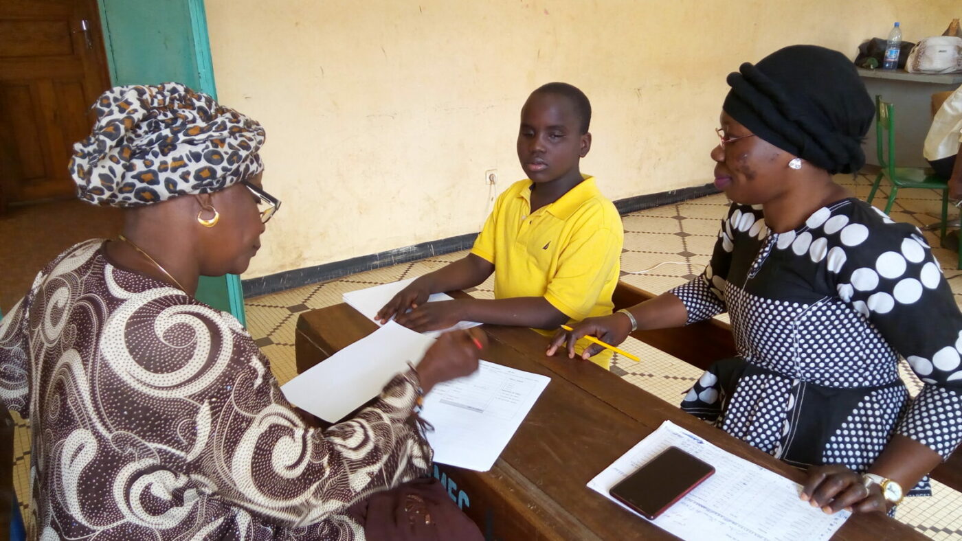 A teacher helps a student.