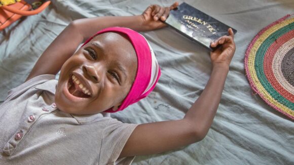 A girl smiles after a cataract operation.