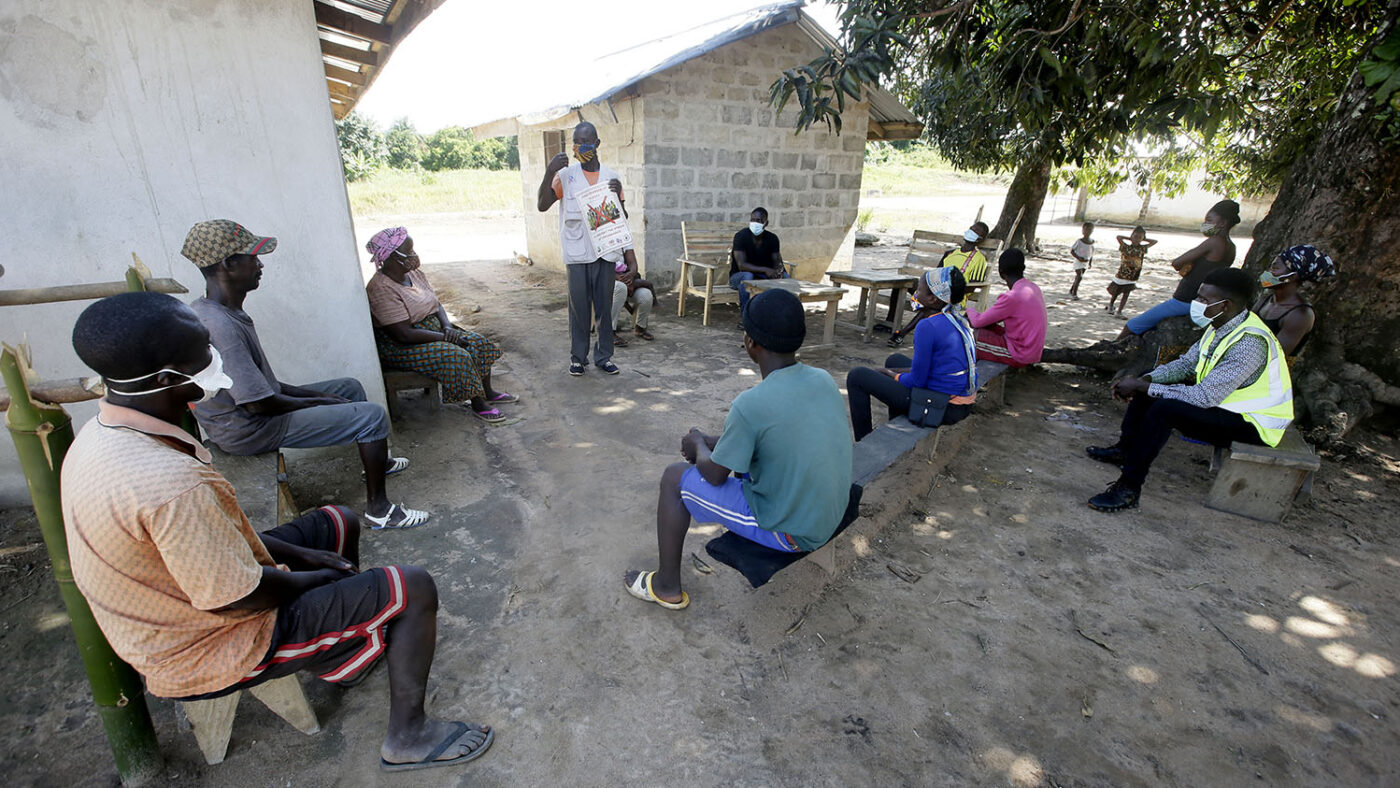A man speaks to a group of people.