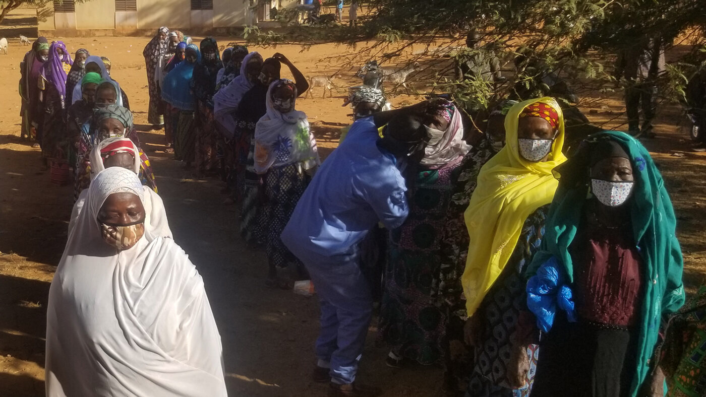 Lines of people in Burkina Faso wait to have their eyes checked.