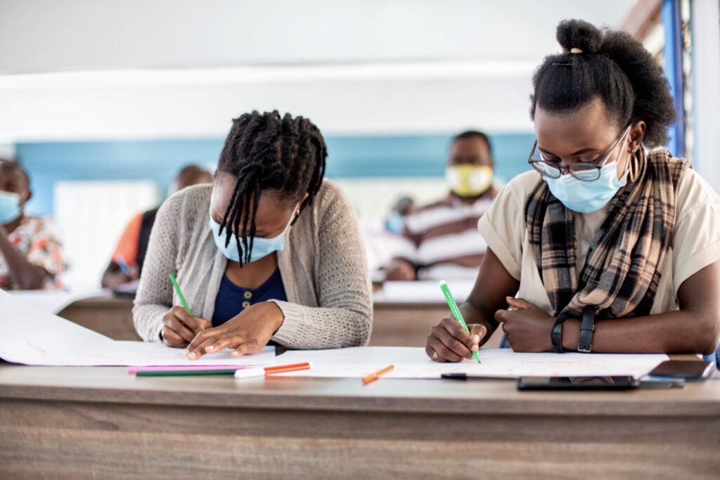 Two girls working in a classroom.