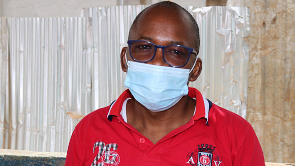 Dr Coulibaly wearing a mask and looking at the camera.